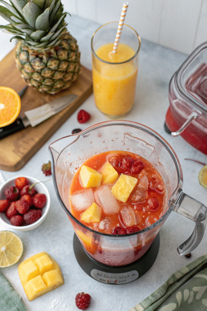 Blending Bahama Mama Mocktail ingredients in a kitchen blender
